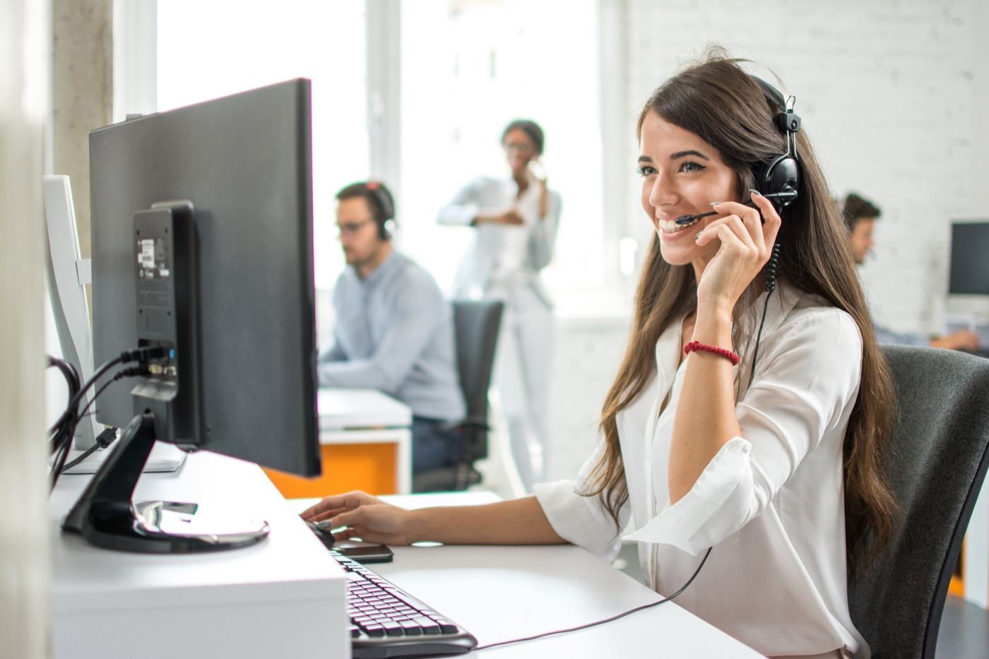 A Vinpro support specialist with a headset assisting a client